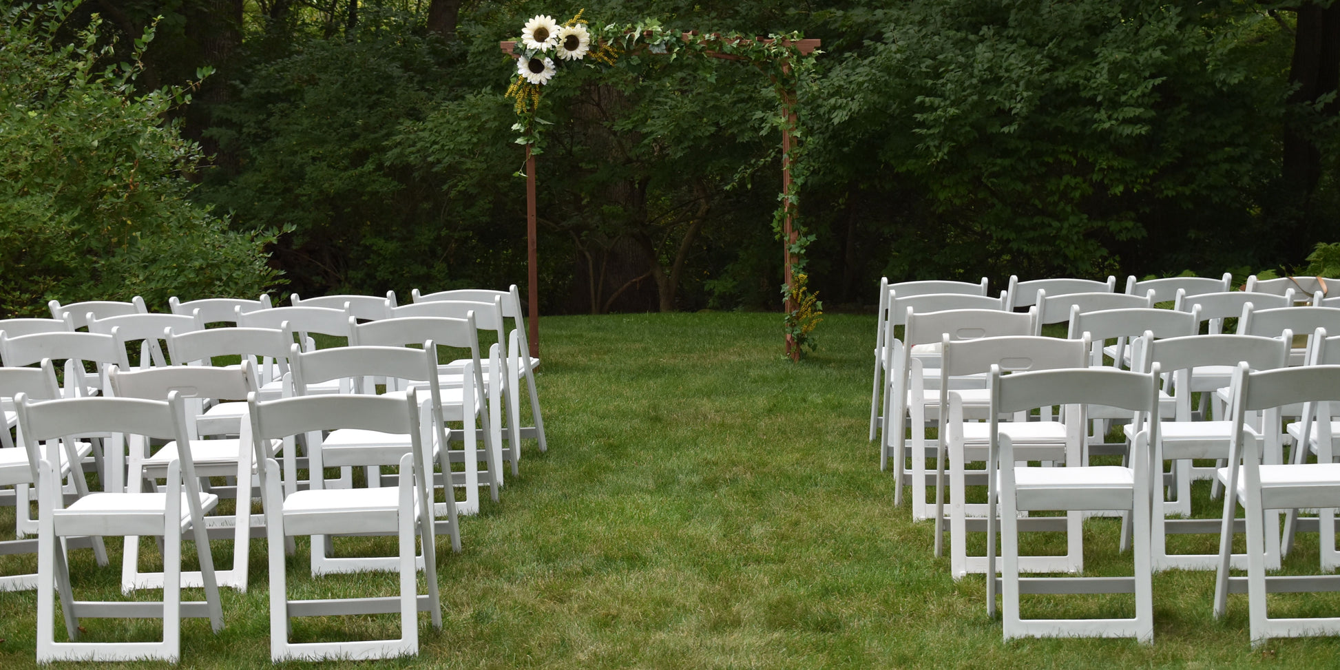 White resin folding chair with a padded seat, ideal for weddings and events. Lightweight, durable, and elegant, perfect for any venue.