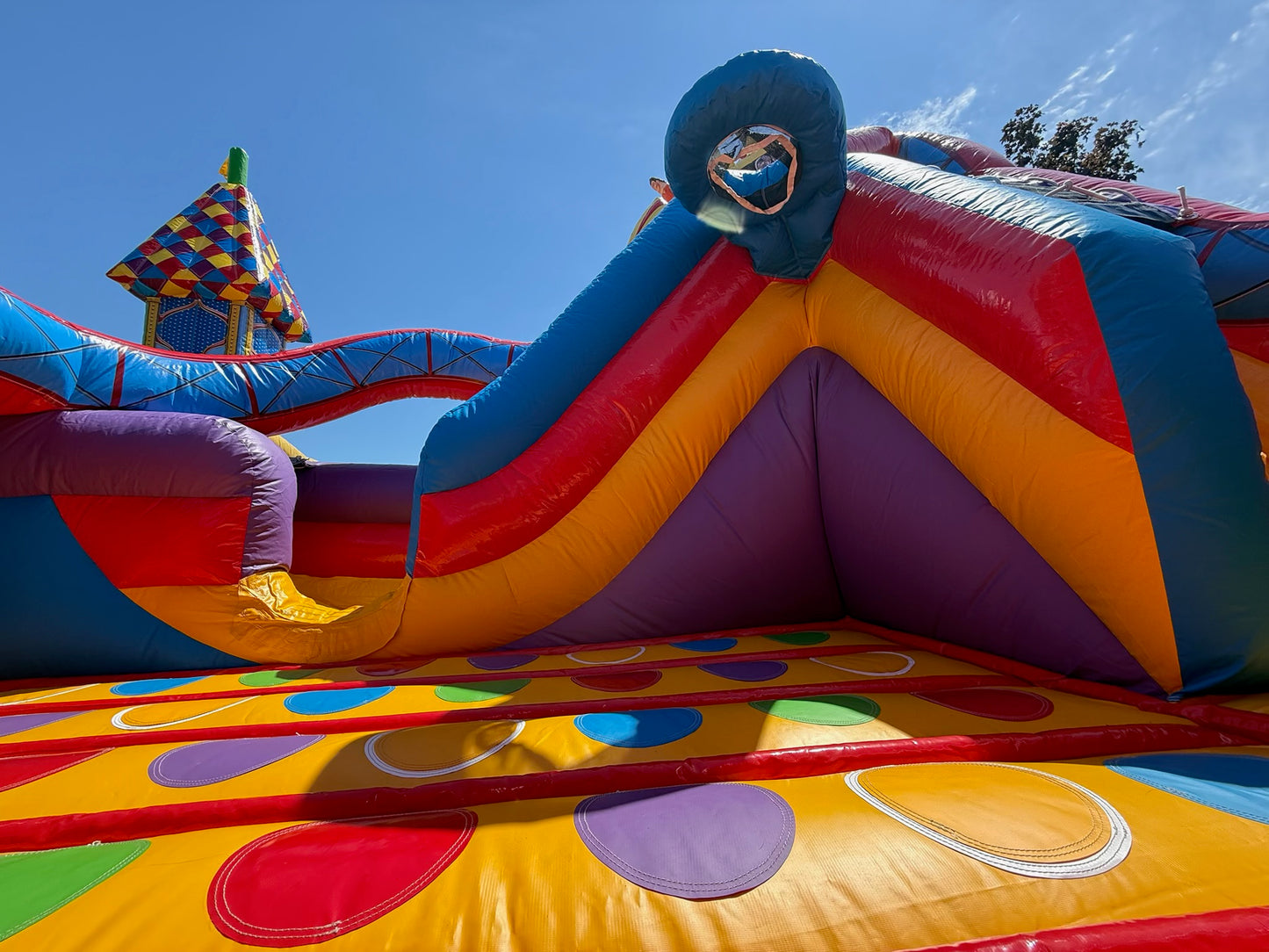 Colorful inflatable playground structure against a blue sky